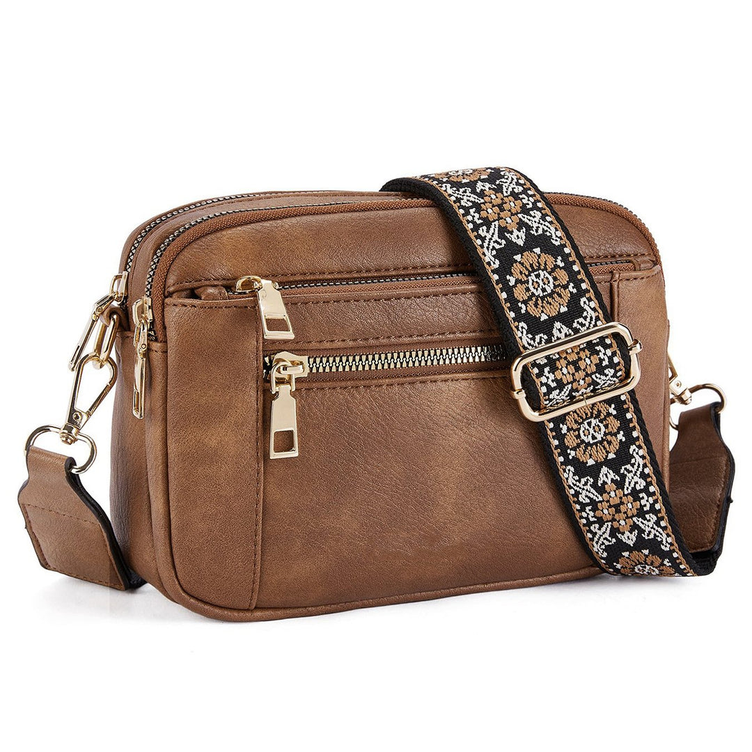 Kobiecza torebka crossbody z wieloma zamkami i nadrukowanym paskiem